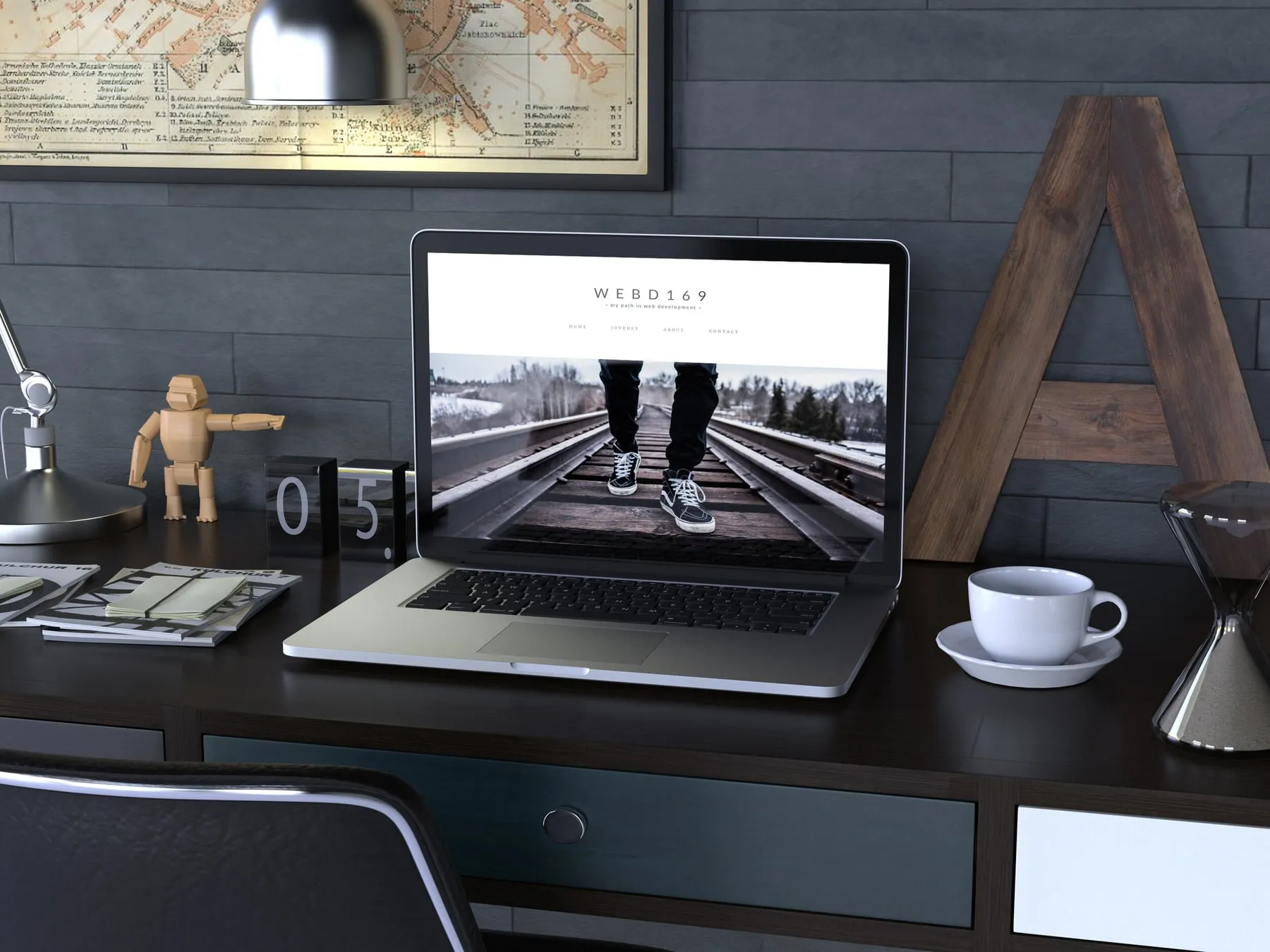 A laptop on a desk showing a completed client website with a photographic hero